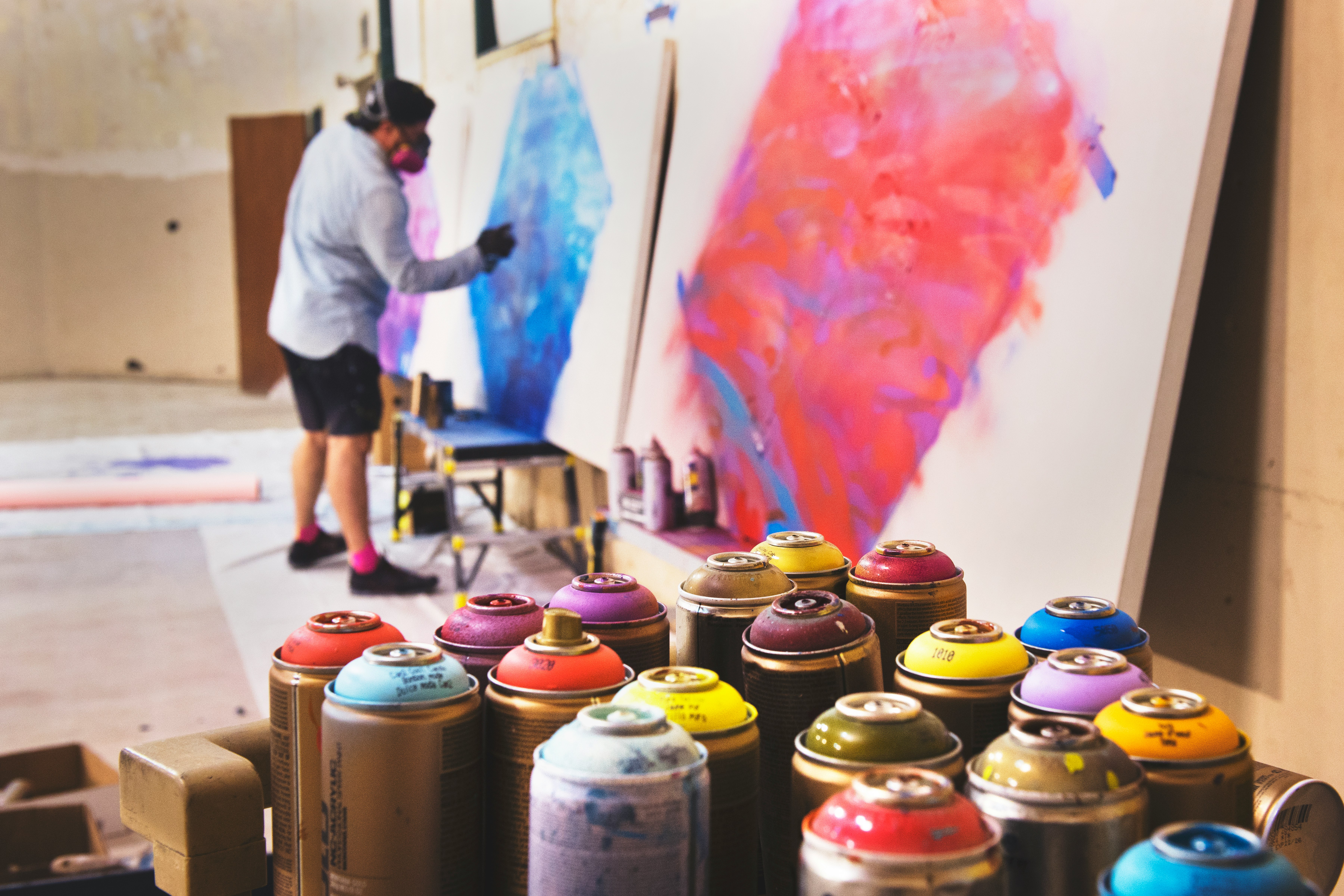 man spraying on white canvas